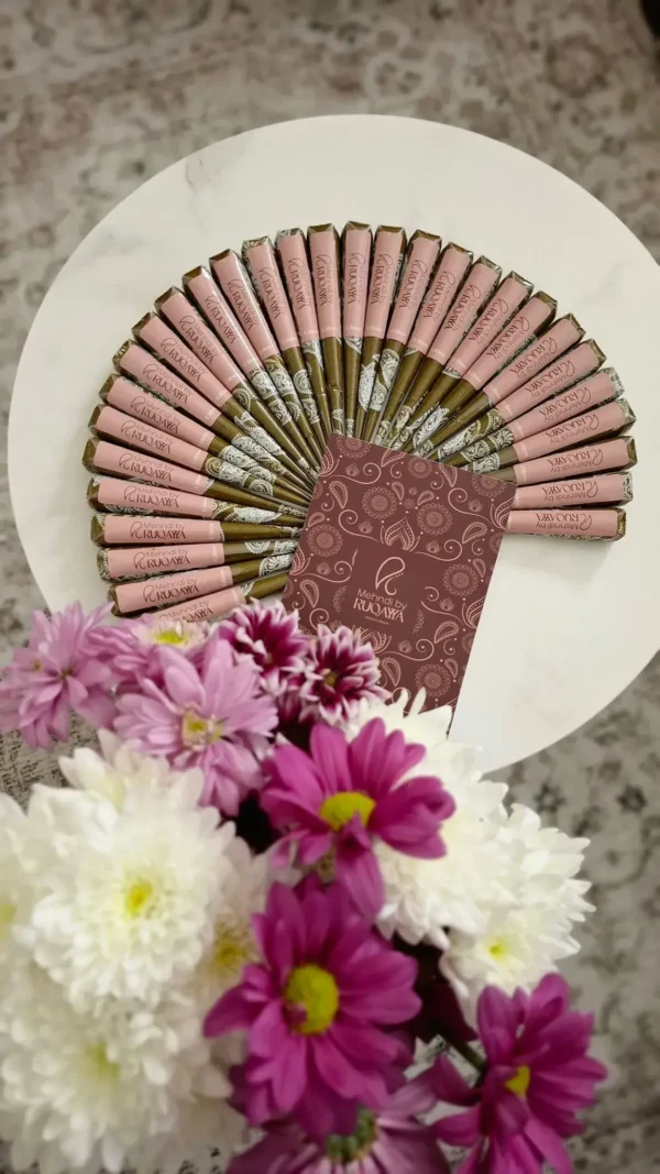 Natural henna cones arranged in a display with MehndiByRuqayya branding